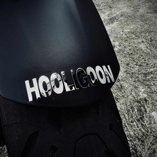 Black helmet with 'HOOLIGOON' text on a textured surface