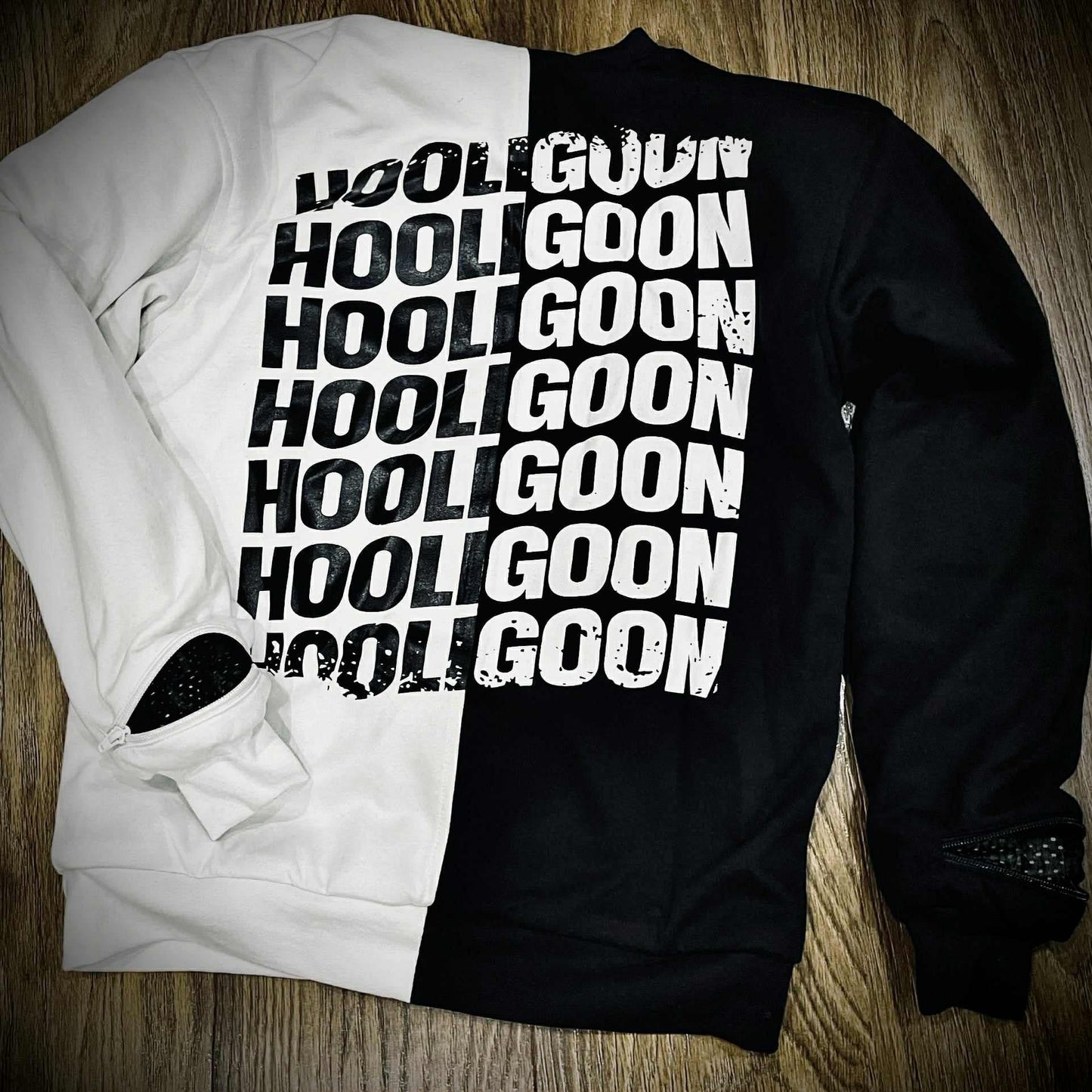 Black and white tee with 'HOOLIGOON' text on a wooden surface