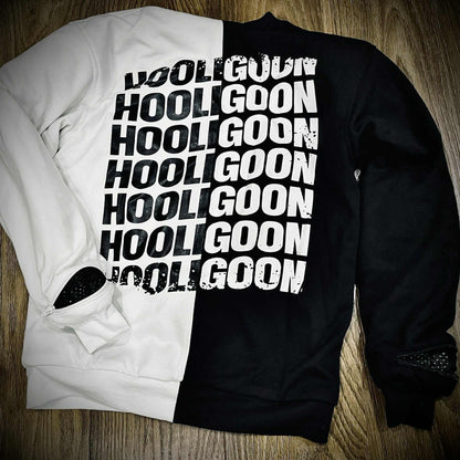 Black and white tee with 'HOOLIGOON' text on a wooden surface