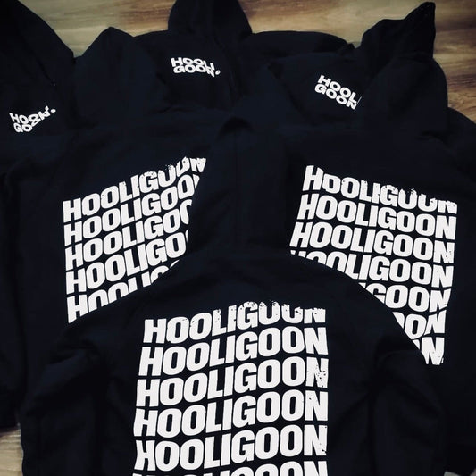 Black hoodies with 'Hooligoon' text on a wooden floor
