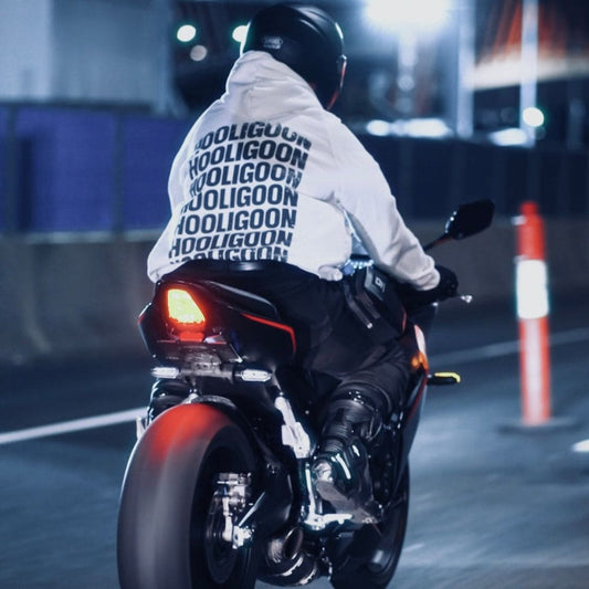 Person riding a motorcycle at night with a blurred background