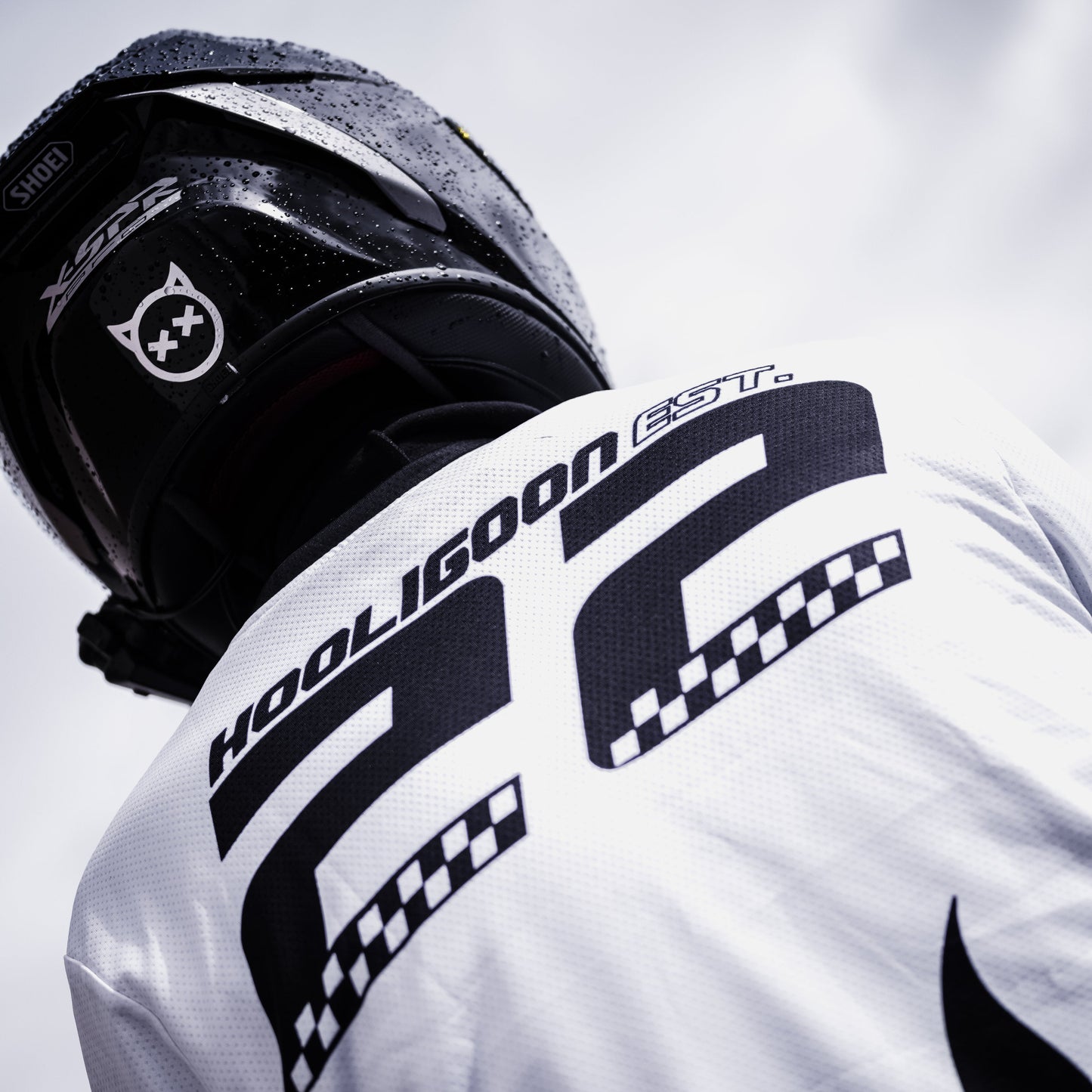Person wearing a white motocross jersey with 'Hooligoon' branding on the back.