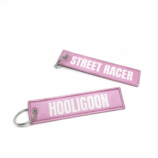Two pink keychains with 'Street Racer' and 'Hooligoon' text on a white background