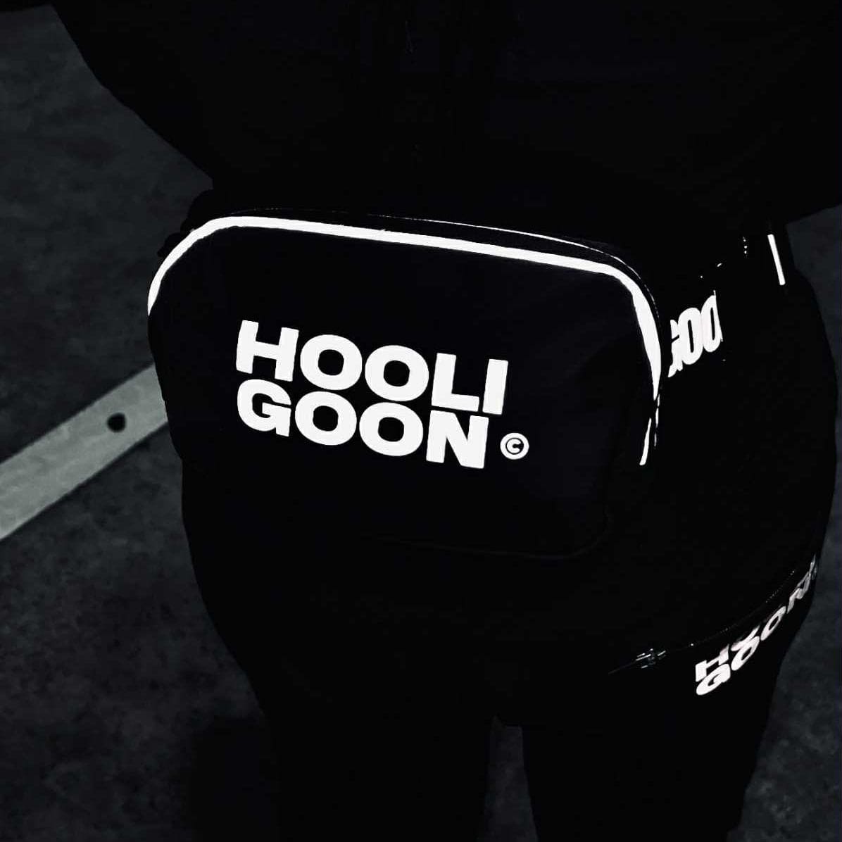 Black pants with 'HOOLIGOON' text on a dark background