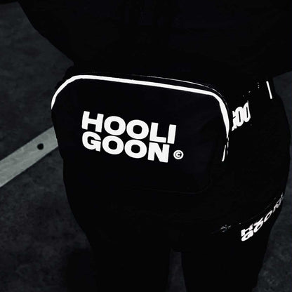 Black pants with 'HOOLIGOON' text on a dark background