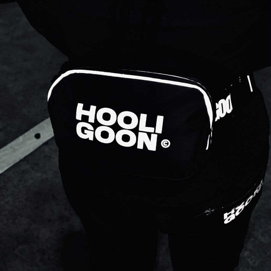 Black pants with 'HOOLIGOON' text on a dark background